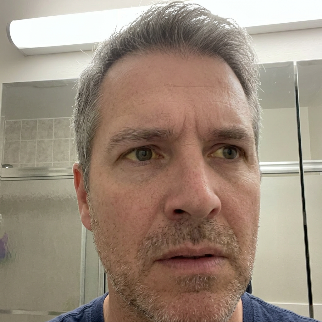 Man looking in bathroom mirror